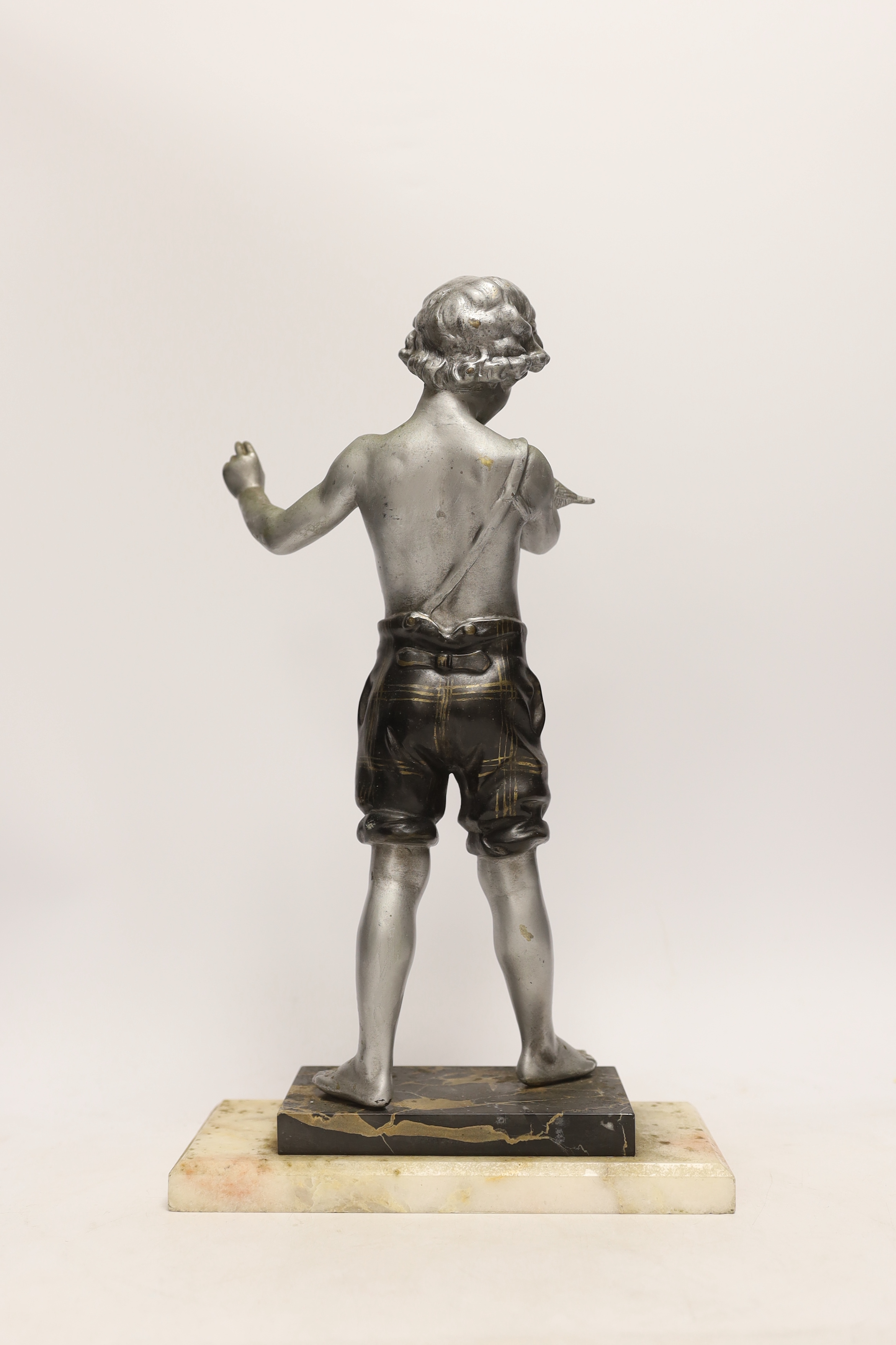 A spelter figure of a boy with bird on two step marble base, 39.5cm high